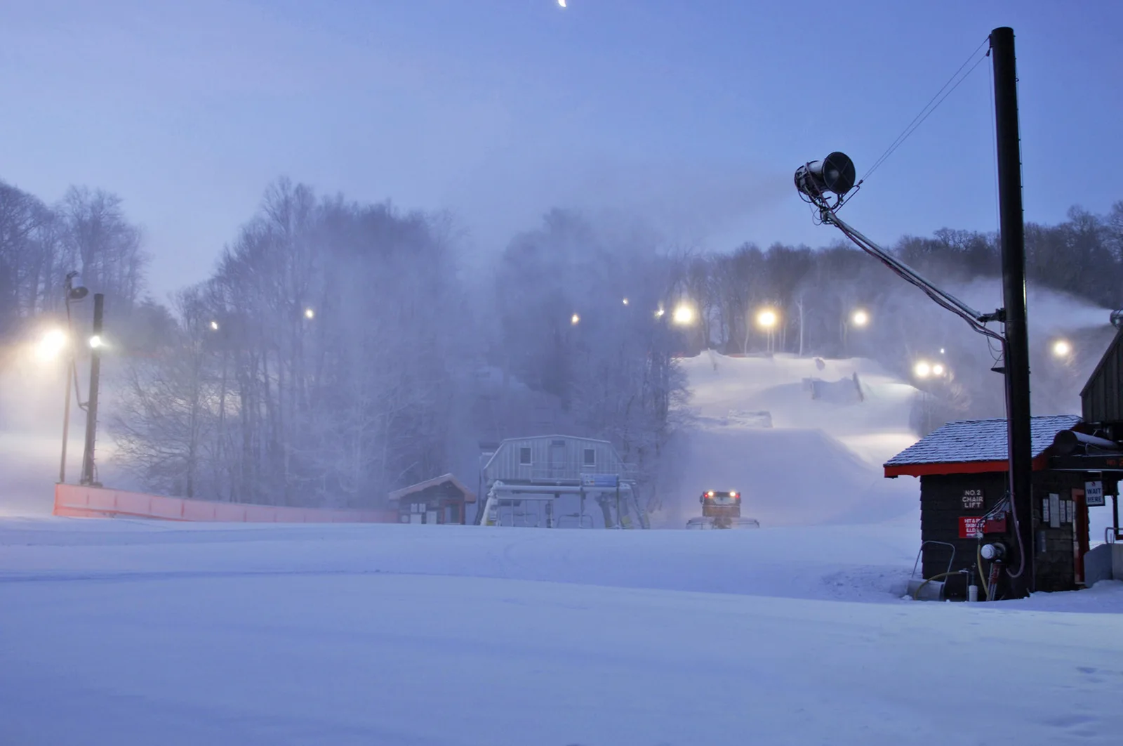 Lighted ski slopes and lift equipment at Appalachian Ski Mtn. on a snowy evening